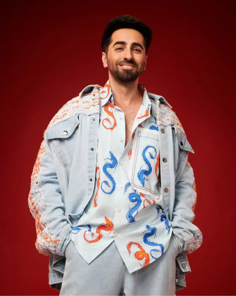 Ayushman Khurana wearing a white colored shirt with blue and orange colored design on it.