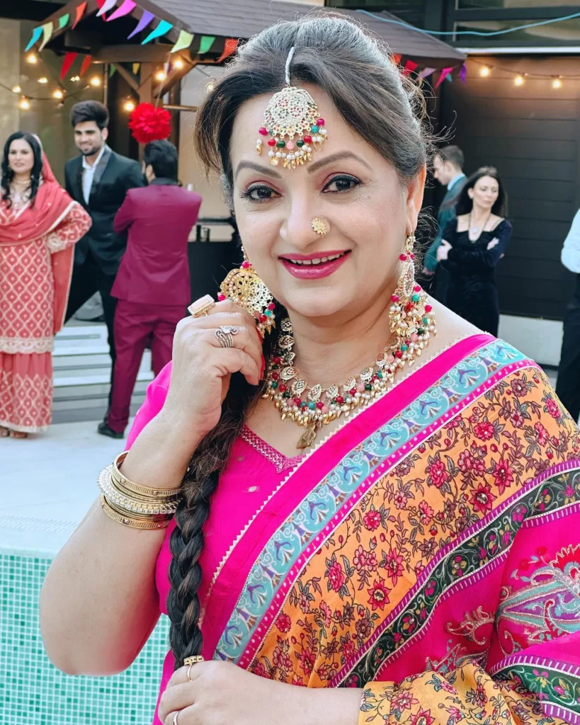 Upasana Singh wearing a pink colored suit and traditional jewellery.